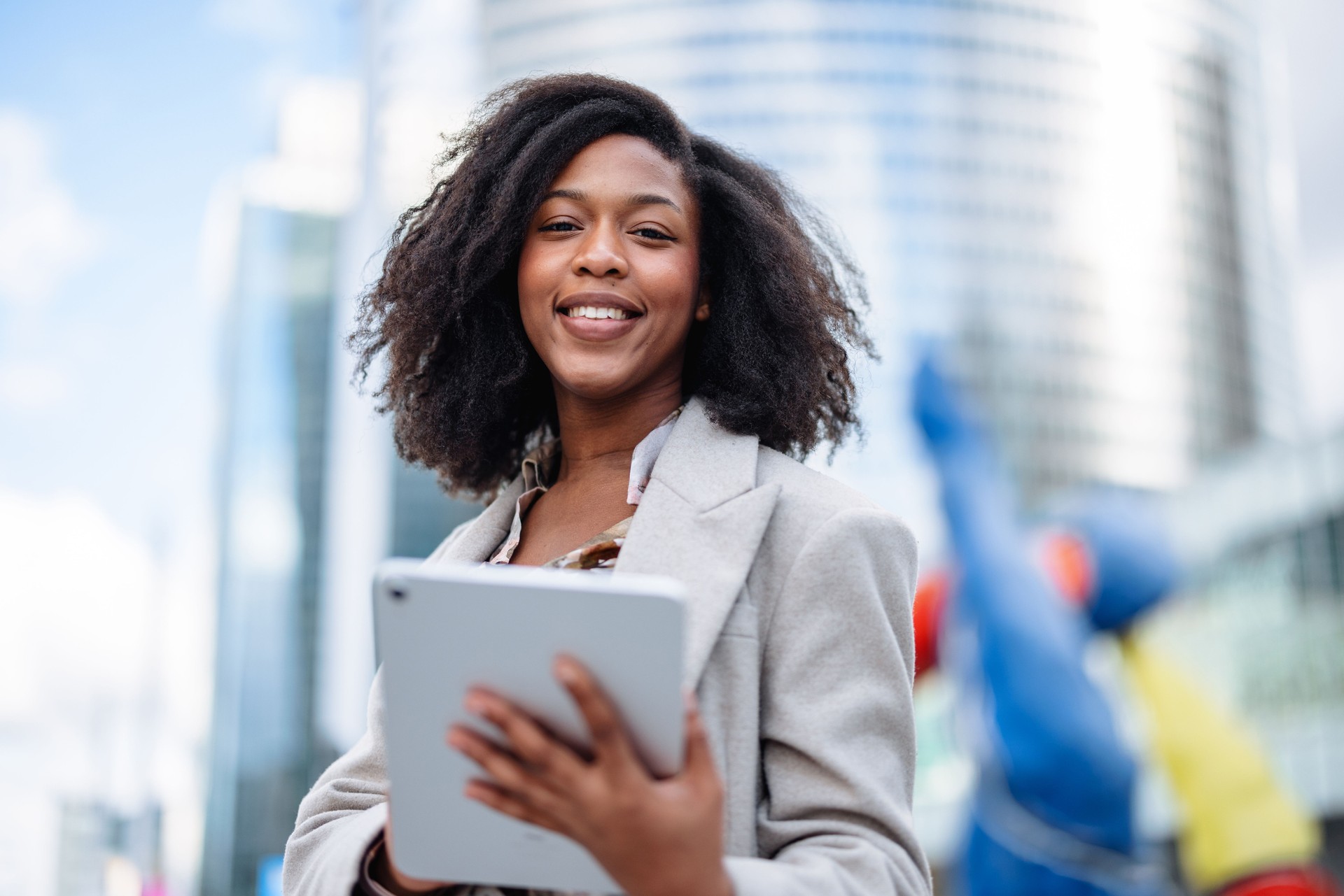 Cheerful Black Businesswoman With Digital Tablet Outside Office